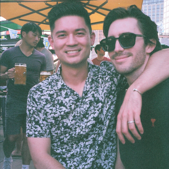 Justin with his arm around Tyler at a beer garden