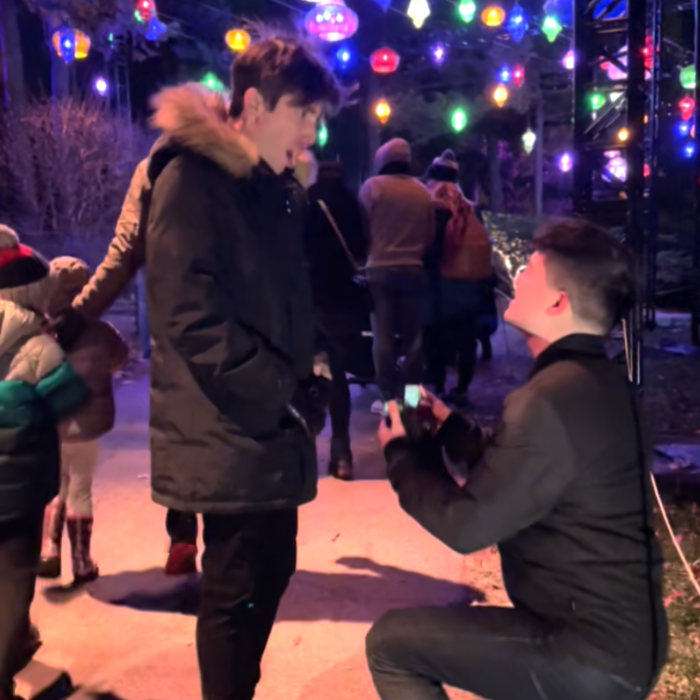 Tyler with a shocked expression, as Justin goes on bended knee