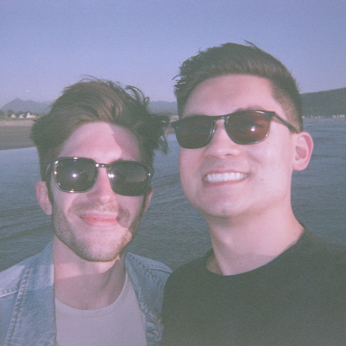 Tyler and Justin smiling at the Oregon Coast