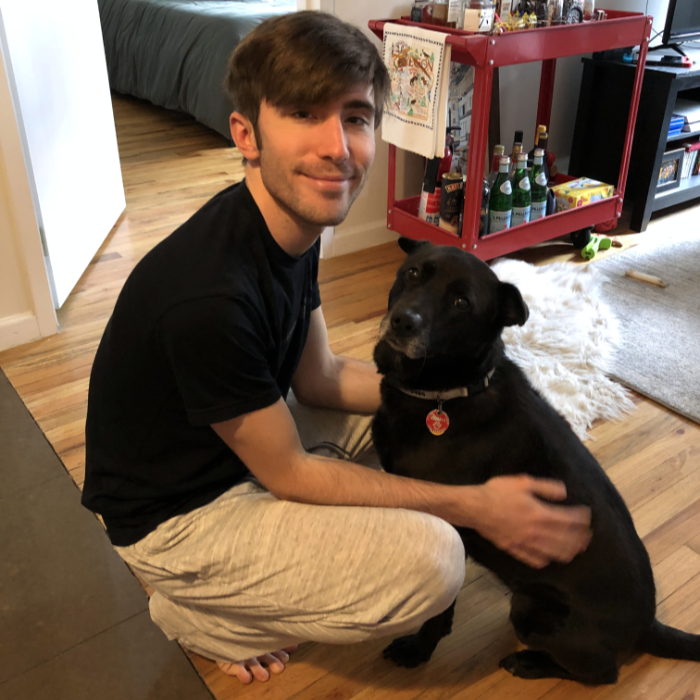 Tyler crouching next to Dino